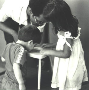 Young children with magnifier